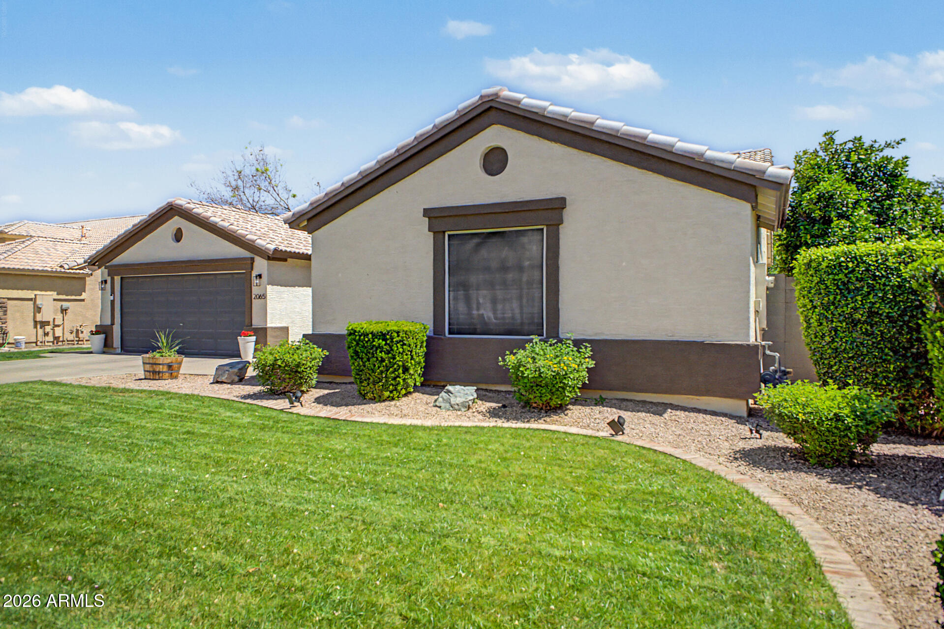2065 South Porter Street Gilbert, AZ 85295 - Photo 3 of 36 a front view of a house with a yard and porch