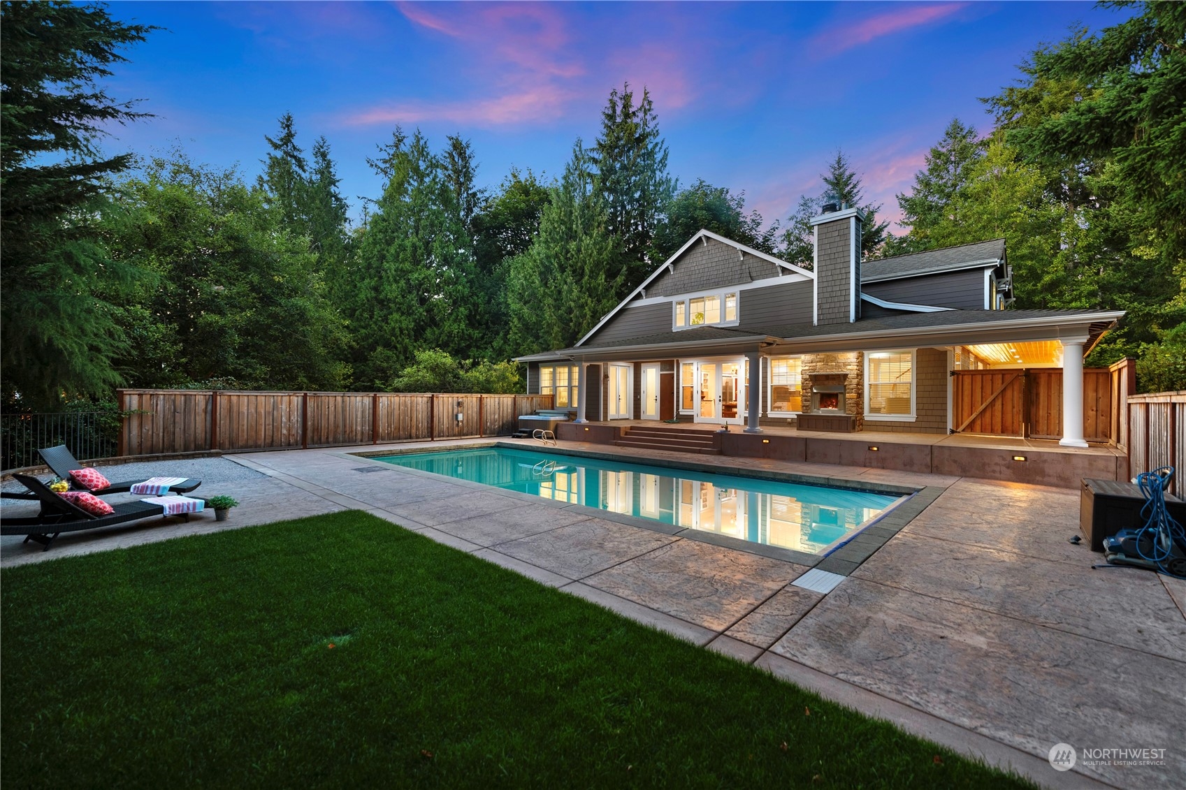 5119 Saddleback Road Northwest Gig Harbor, WA 98332 - Photo 1 of 40 a front view of a house with a yard table and chairs