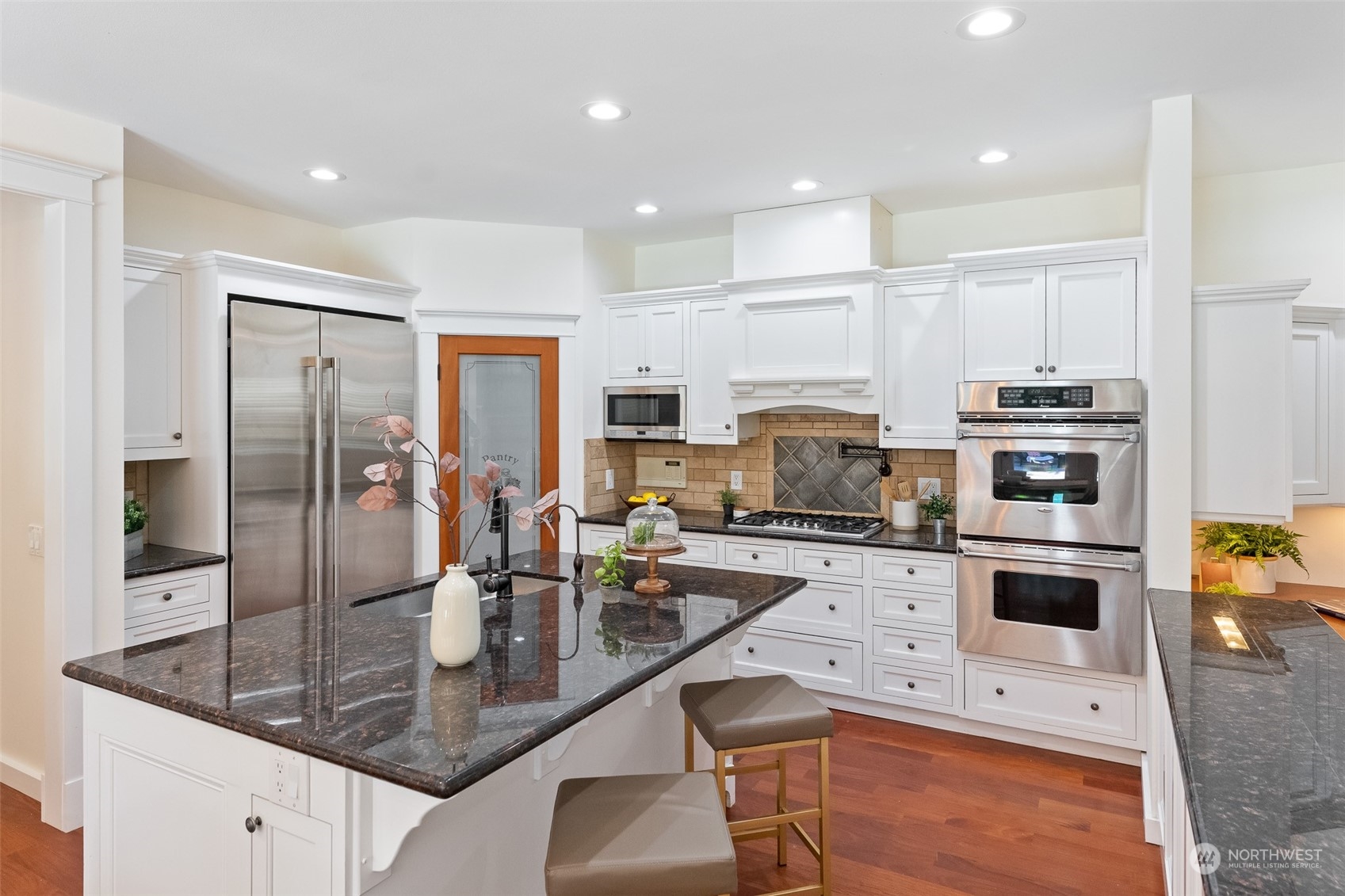 5119 Saddleback Road Northwest Gig Harbor, WA 98332 - Photo 12 of 40 a kitchen with stainless steel appliances granite countertop a sink refrigerator and cabinets