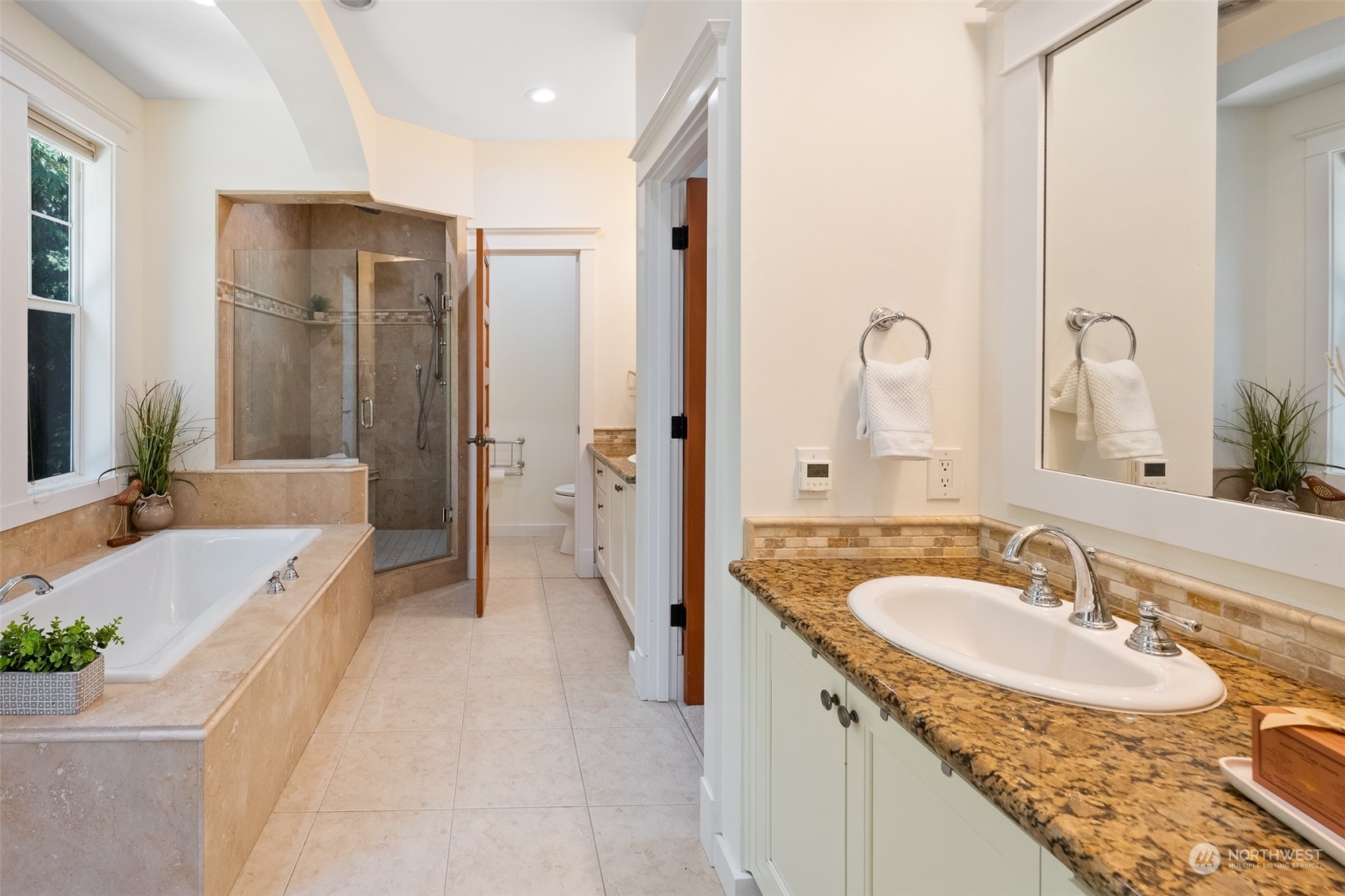 5119 Saddleback Road Northwest Gig Harbor, WA 98332 - Photo 20 of 40 a spacious bathroom with a granite countertop tub sink and mirror