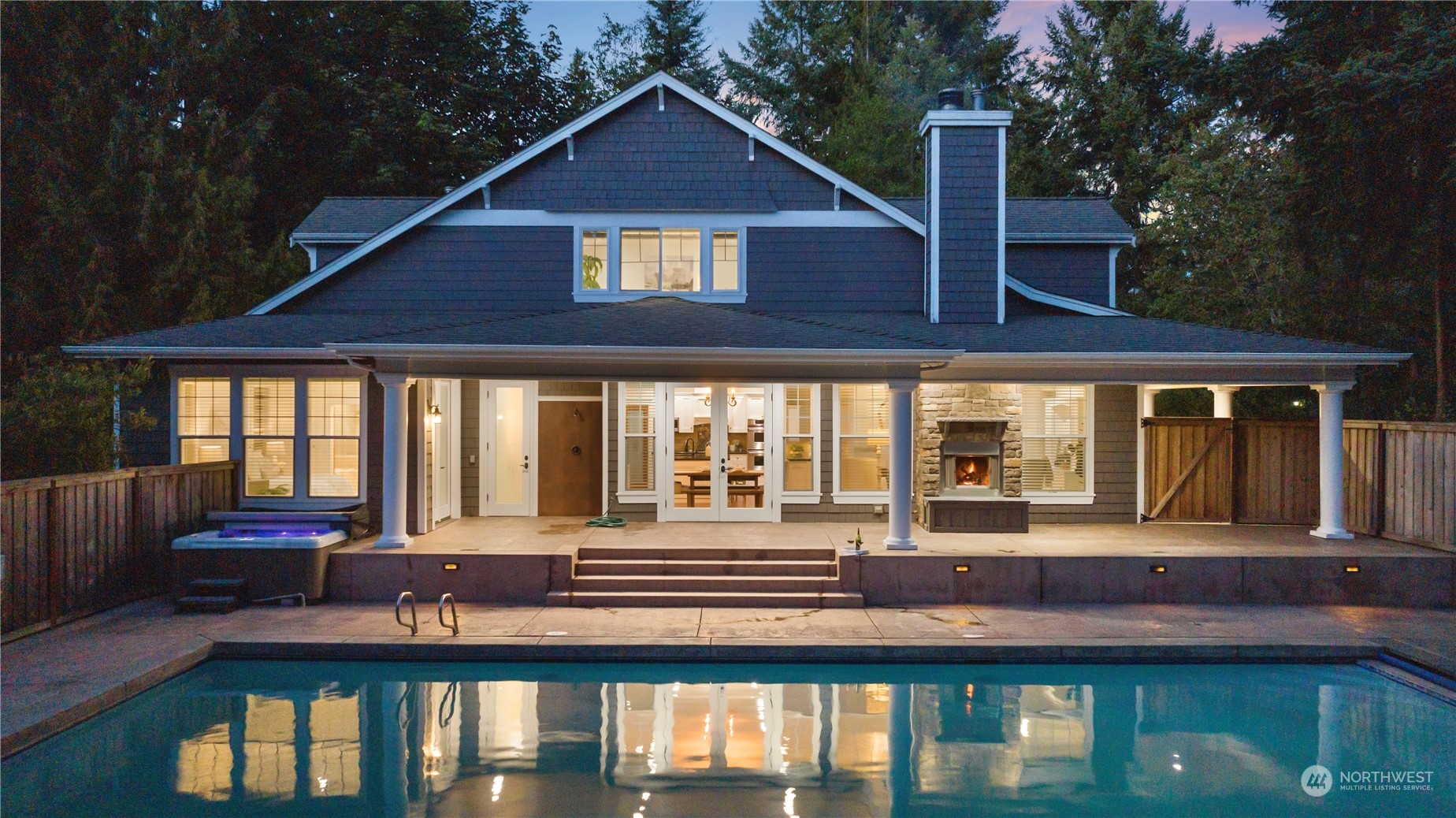5119 Saddleback Road Northwest Gig Harbor, WA 98332 - Photo 2 of 40 a front view of a house with large windows and a table