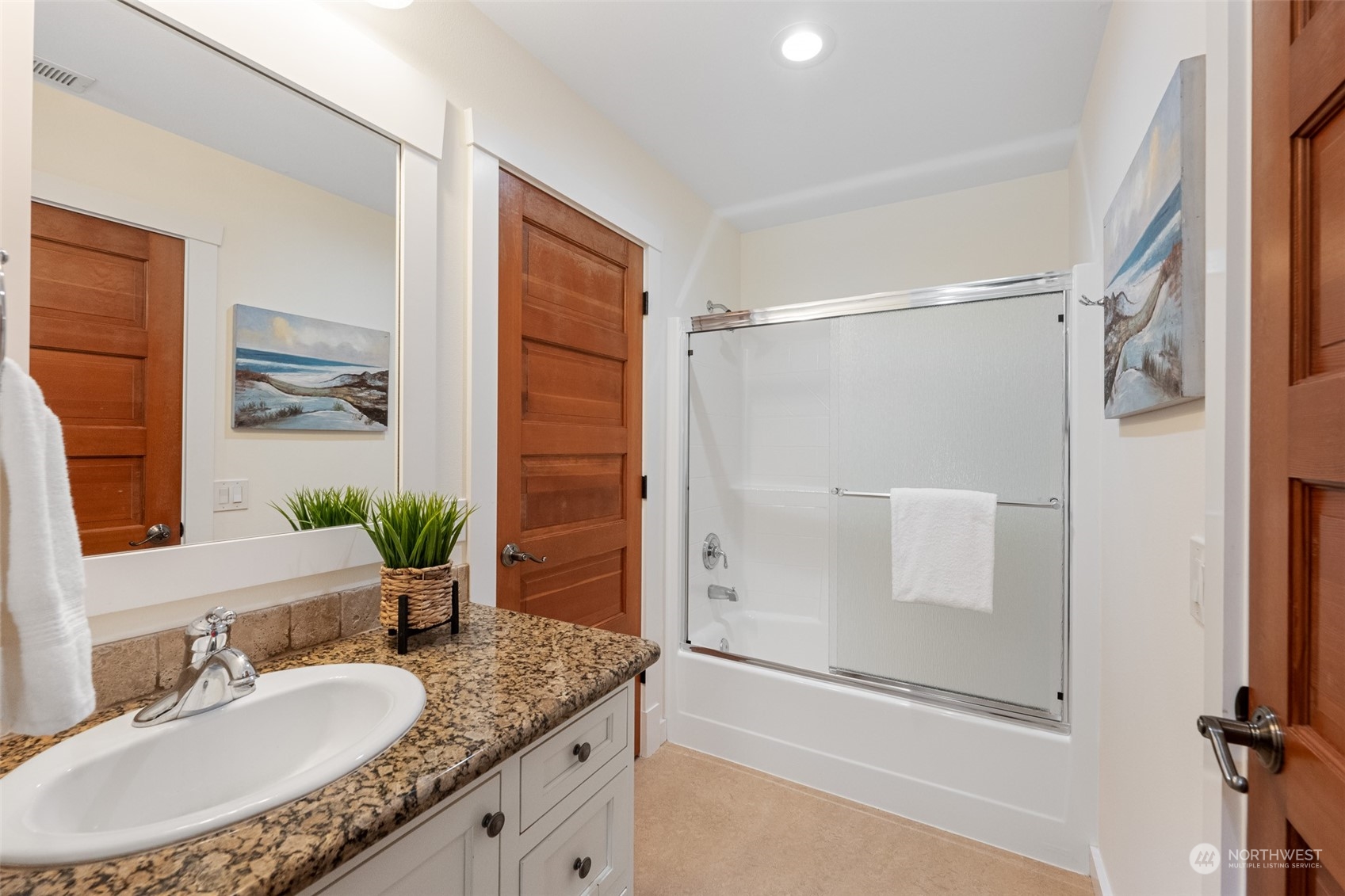 5119 Saddleback Road Northwest Gig Harbor, WA 98332 - Photo 31 of 40 a bathroom with a granite countertop shower sink and mirror