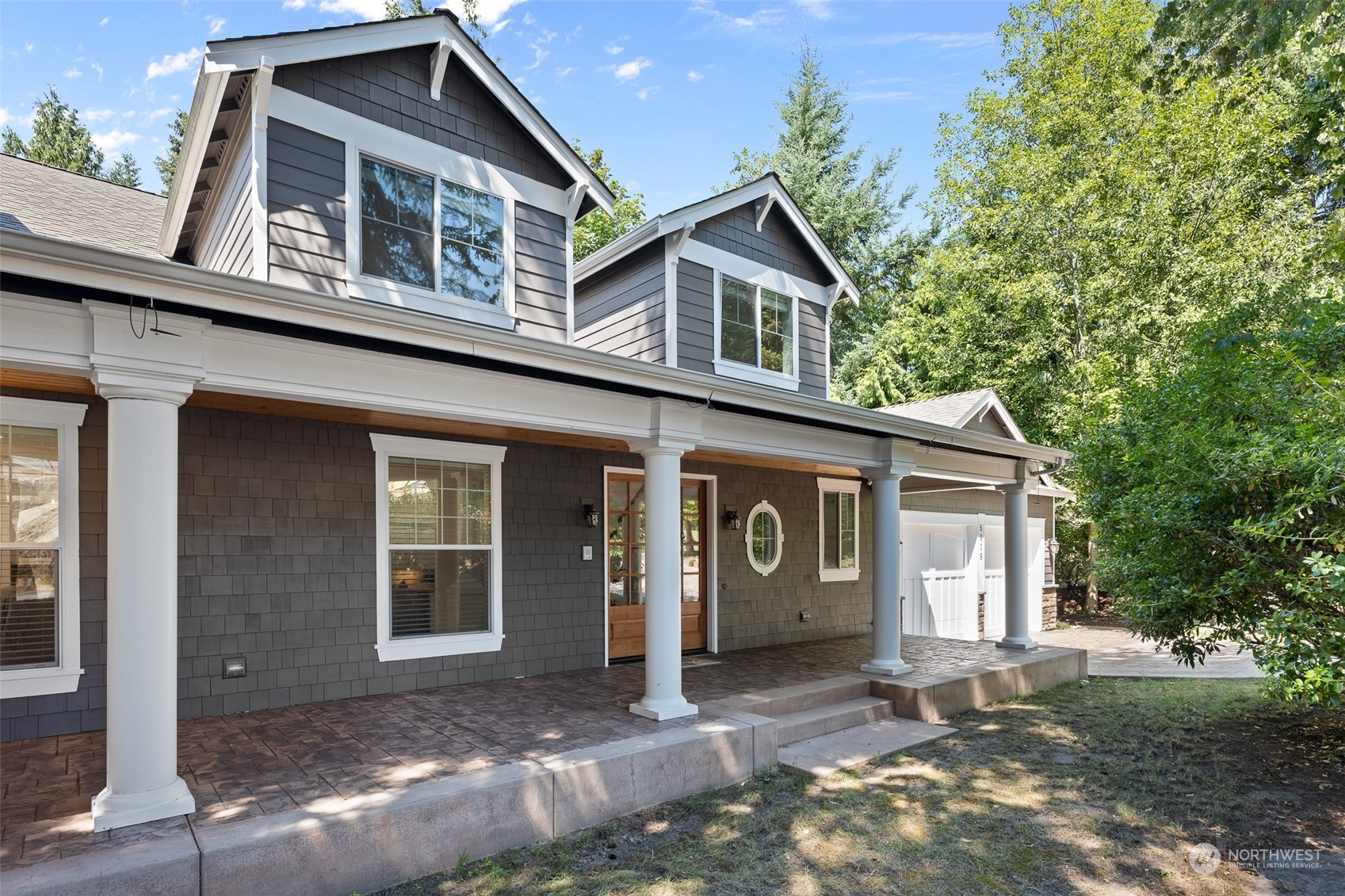 5119 Saddleback Road Northwest Gig Harbor, WA 98332 - Photo 5 of 40 a front view of a house with a yard and garage