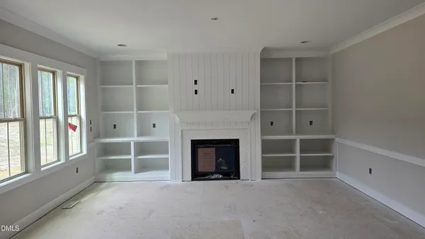 a view of a livingroom with a fireplace and window