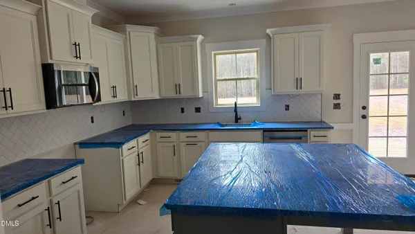 a kitchen with wooden floors and cabinets