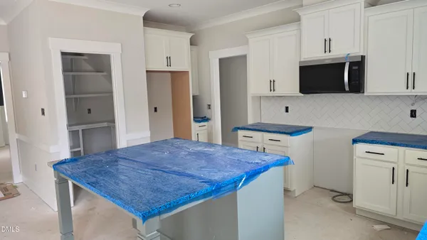 a kitchen with stainless steel appliances a kitchen island a stove and a refrigerator