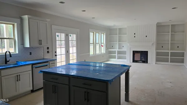 a kitchen with a wooden floor and a sink