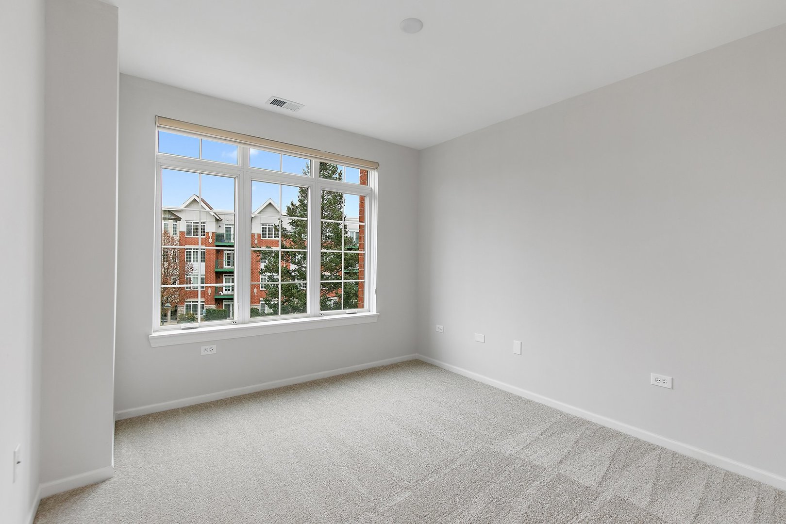640 McHenry Road, Unit 303 Wheeling, IL 60090 - Photo 14 of 20 an empty room with a window