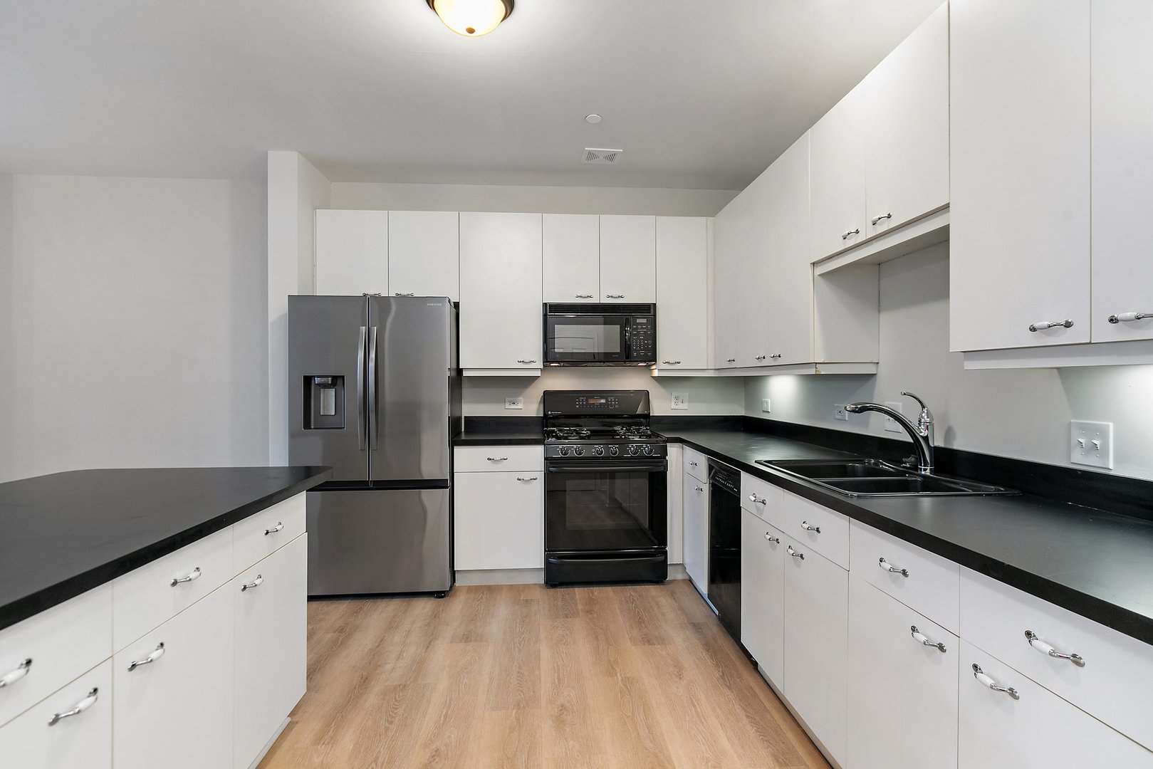 640 McHenry Road, Unit 303 Wheeling, IL 60090 - Photo 2 of 20 a kitchen with granite countertop a refrigerator stove and sink