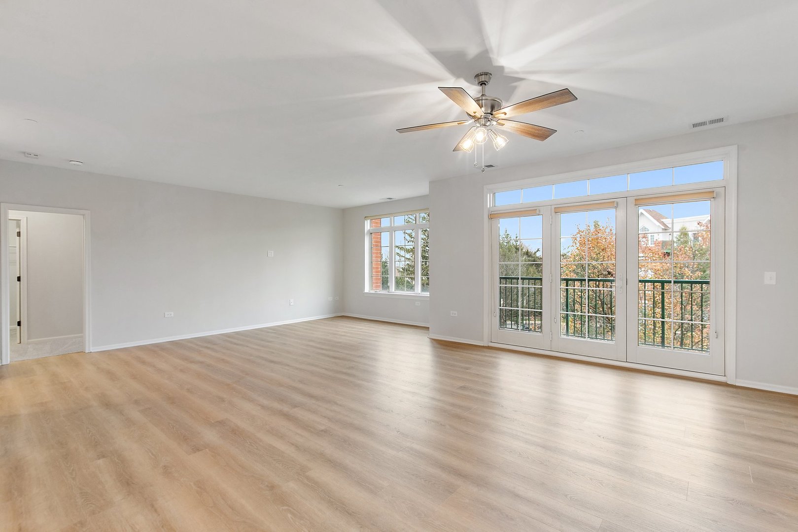 640 McHenry Road, Unit 303 Wheeling, IL 60090 - Photo 6 of 20 a view of an empty room with window and wooden floor