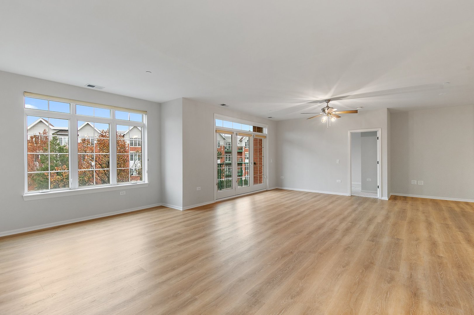 640 McHenry Road, Unit 303 Wheeling, IL 60090 - Photo 7 of 20 a view of an empty room with a window and wooden floor