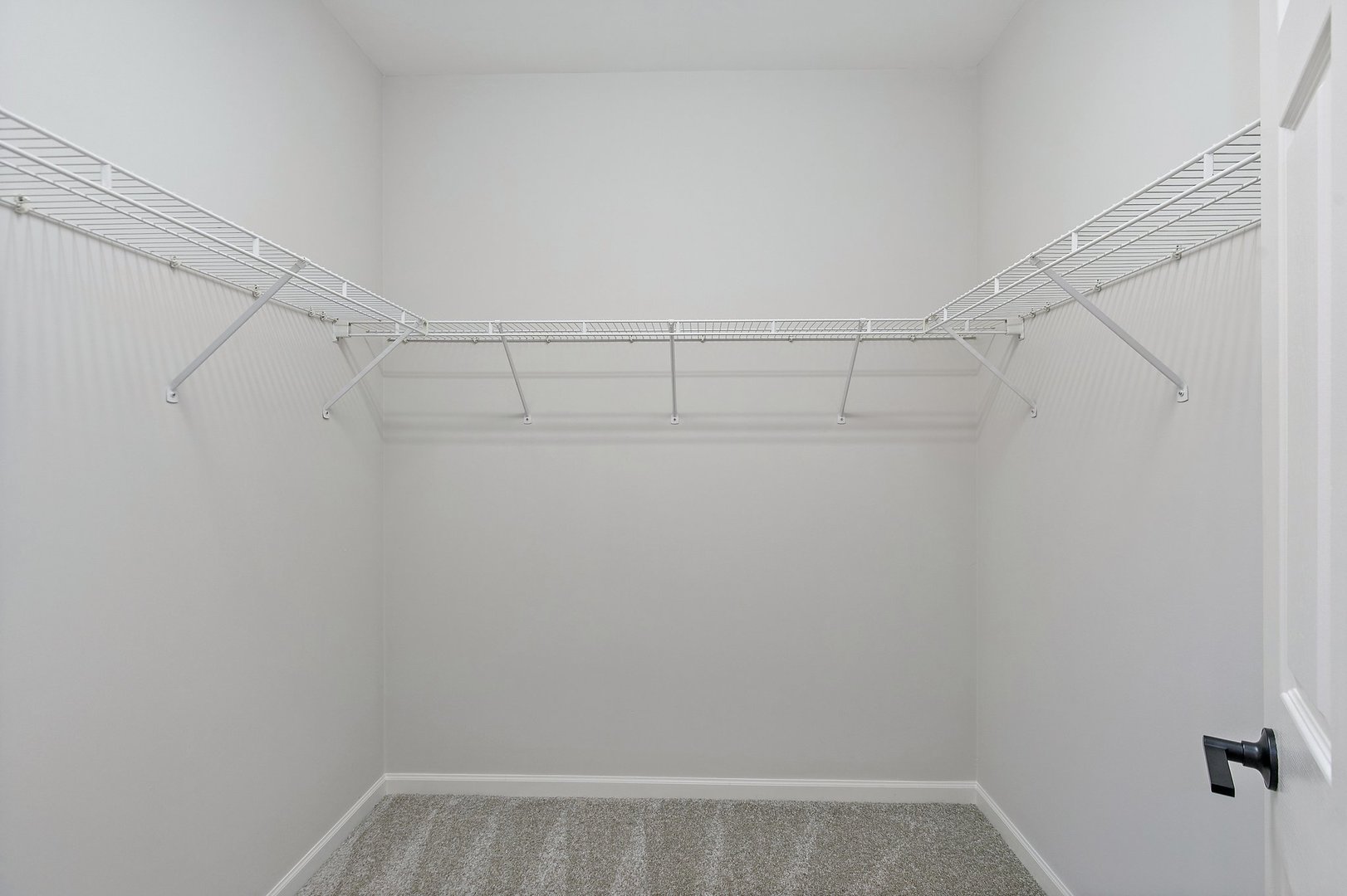 640 McHenry Road, Unit 303 Wheeling, IL 60090 - Photo 10 of 20 a view of a room with racks on the wall