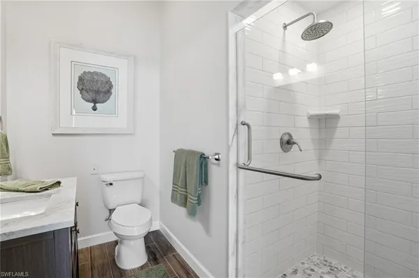 a bathroom with a toilet sink and shower