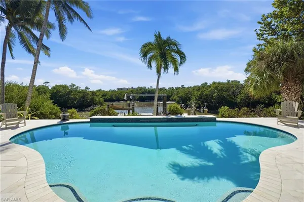 a view of a swimming pool and lounge chair