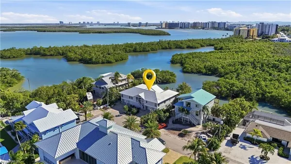 an aerial view of a house with outdoor space and lake view