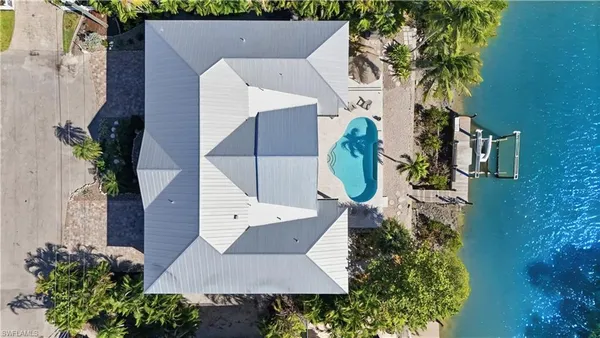 an aerial view of a house with a swimming pool