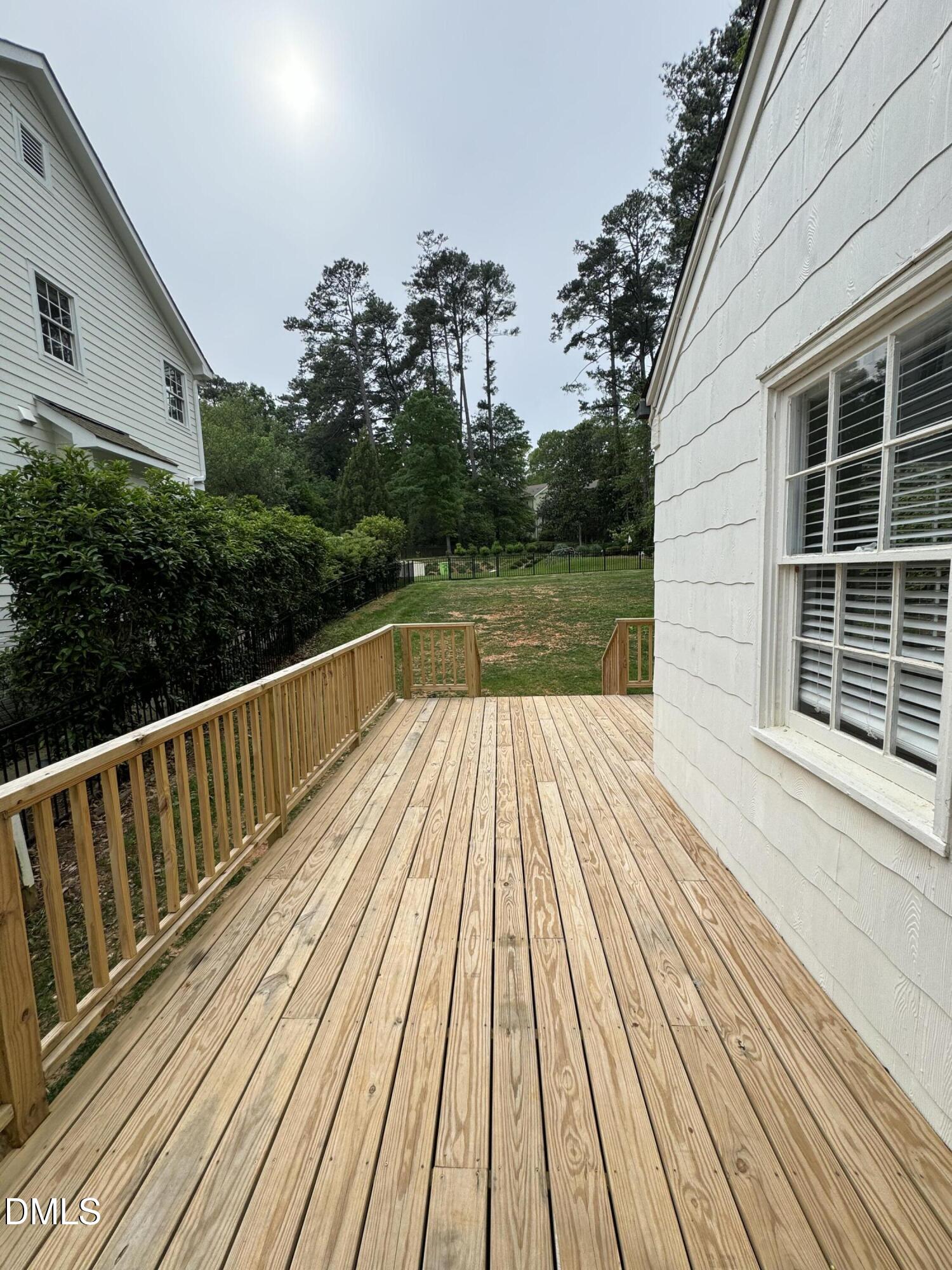 1009 Canterbury Road Raleigh, NC 27607 - Photo 17 of 31 a view of balcony with wooden floor and fence