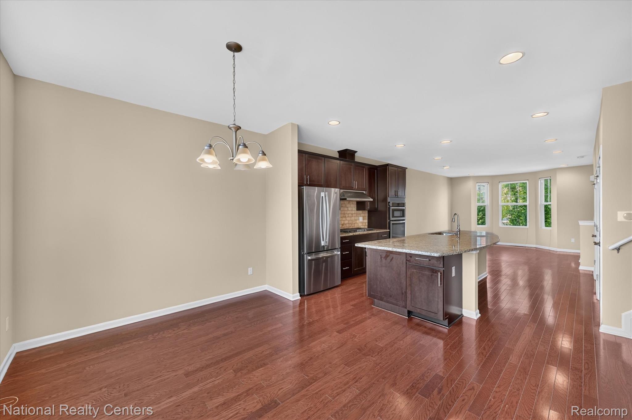 330 Glenhurst Boulevard Rochester, MI 48307 - Photo 20 of 47 Hardwood flooring, recessed lighting, stainless steel appliances, kitchen island with built-in sink, and bay windows