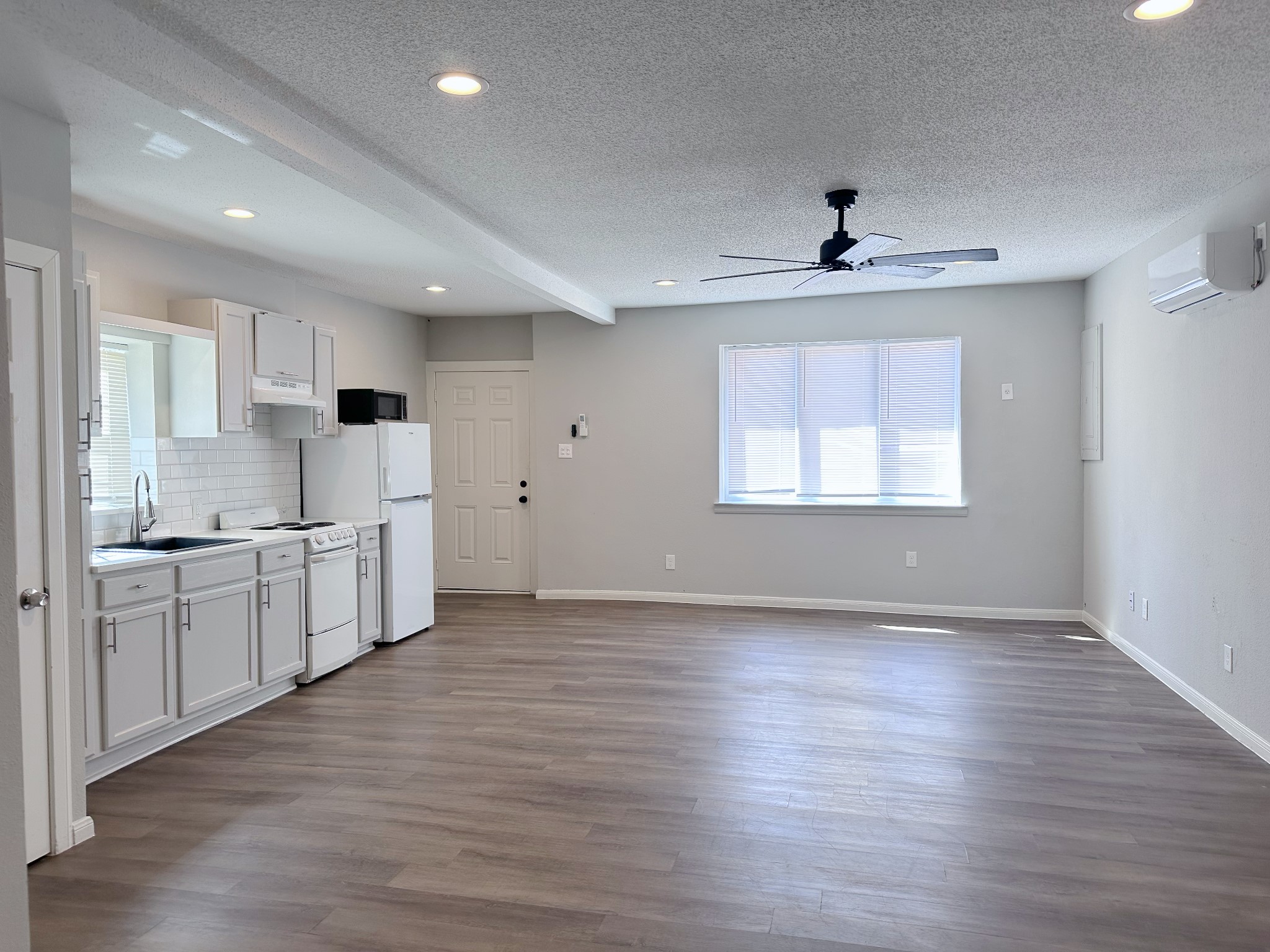 2704 Brewster Street Houston, TX 77026 - Photo 8 of 10 a large kitchen with stainless steel appliances a large counter top a sink and a window