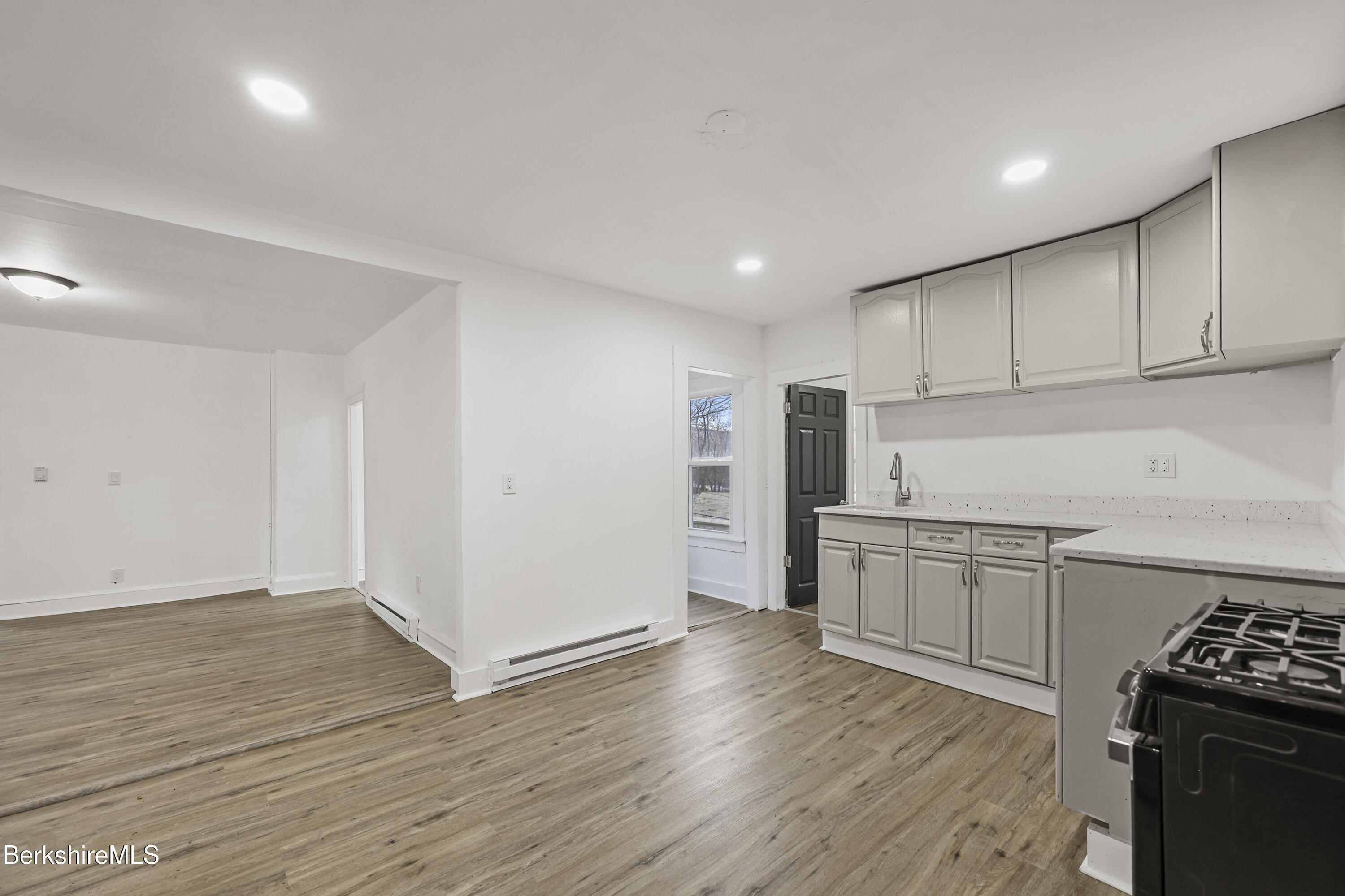 41 Prospect Street North Adams, MA 01247 - Photo 11 of 34 a kitchen with granite countertop a stove top oven a sink dishwasher and a refrigerator with wooden floor