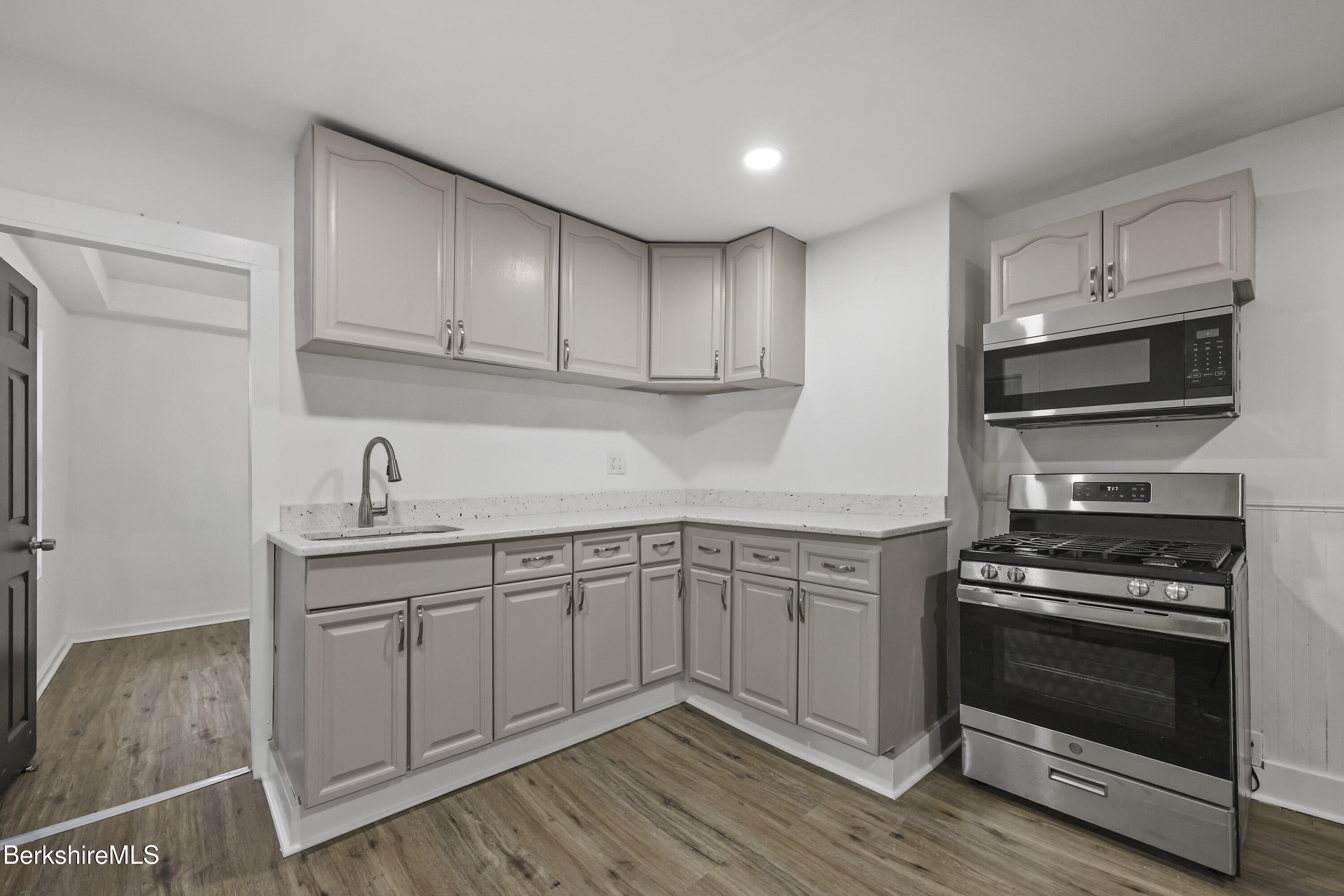 41 Prospect Street North Adams, MA 01247 - Photo 12 of 34 a kitchen with stainless steel appliances granite countertop a stove and white cabinets
