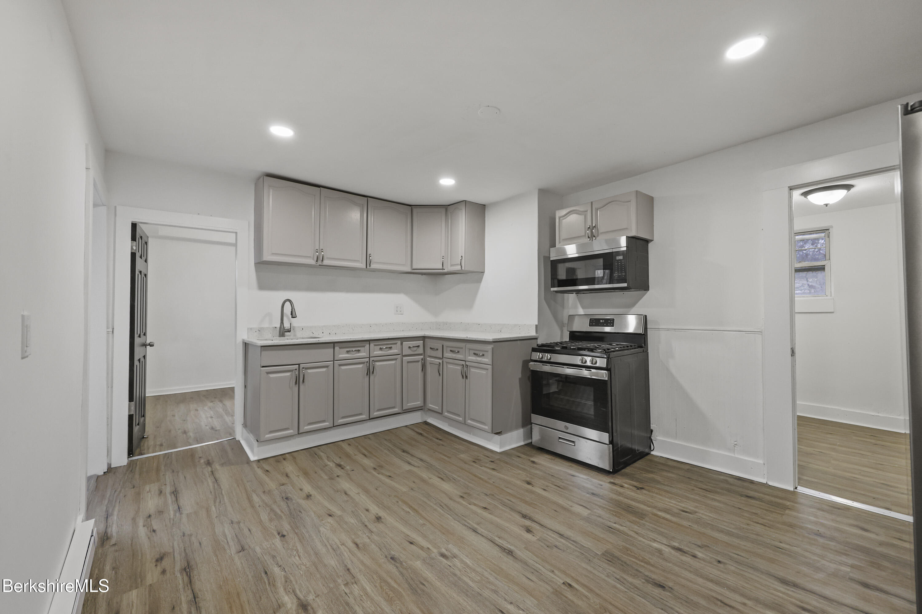 41 Prospect Street North Adams, MA 01247 - Photo 13 of 34 a kitchen with stainless steel appliances and a wooden floor