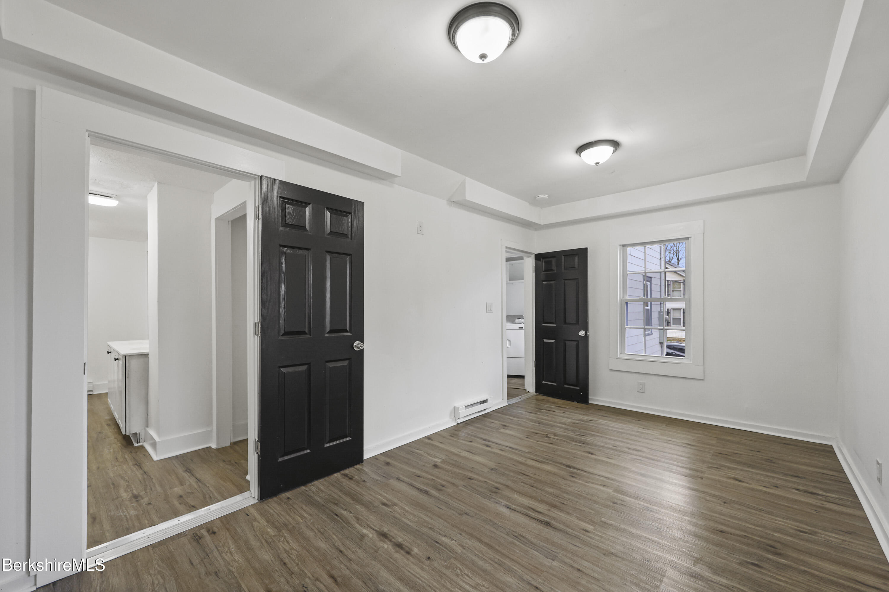 41 Prospect Street North Adams, MA 01247 - Photo 14 of 34 an empty room with wooden floor and windows
