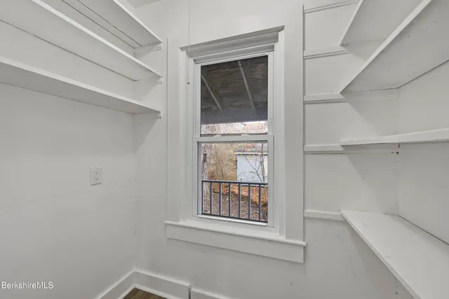 a view of an empty room with closet
