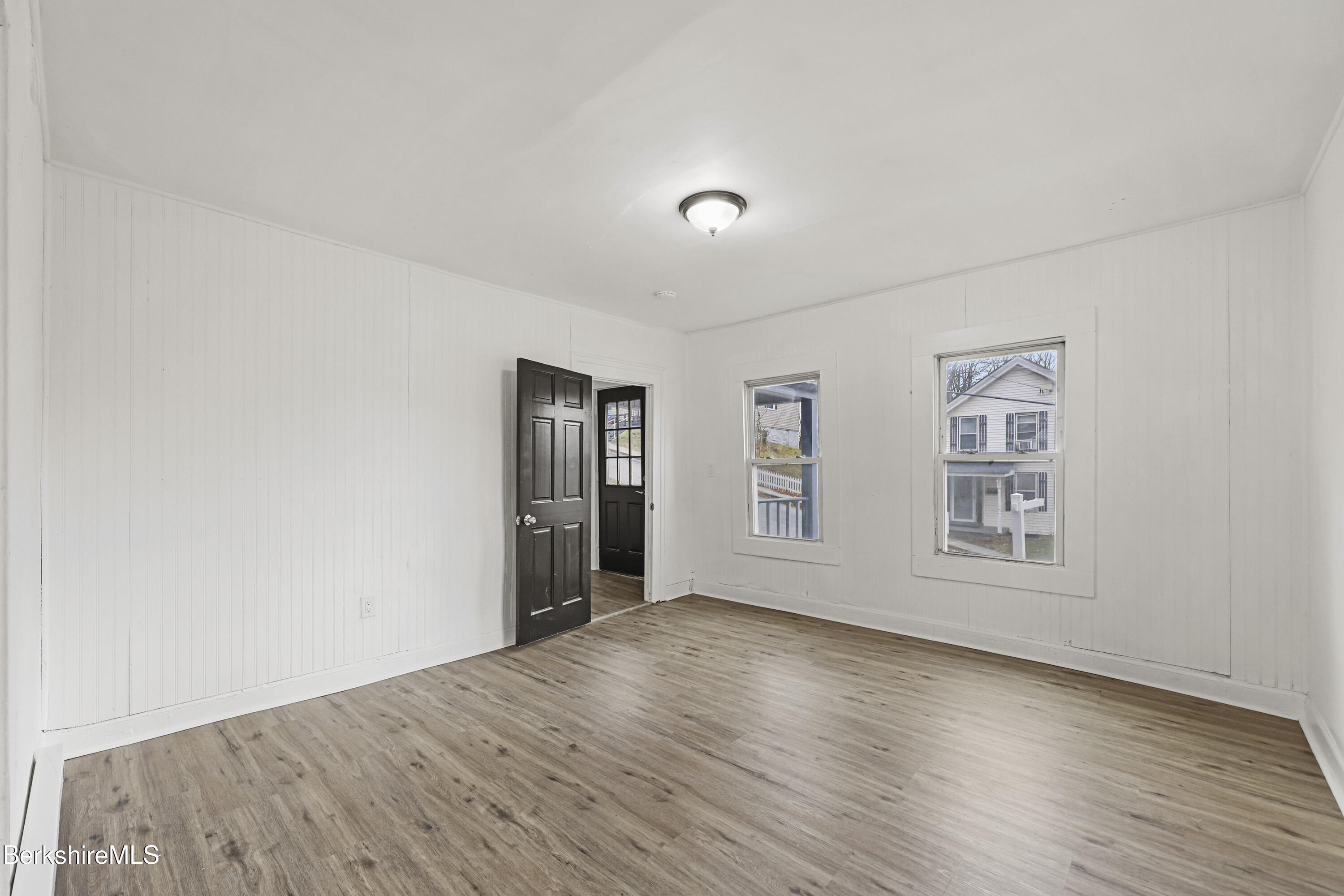 41 Prospect Street North Adams, MA 01247 - Photo 4 of 34 an empty room with wooden floor and windows