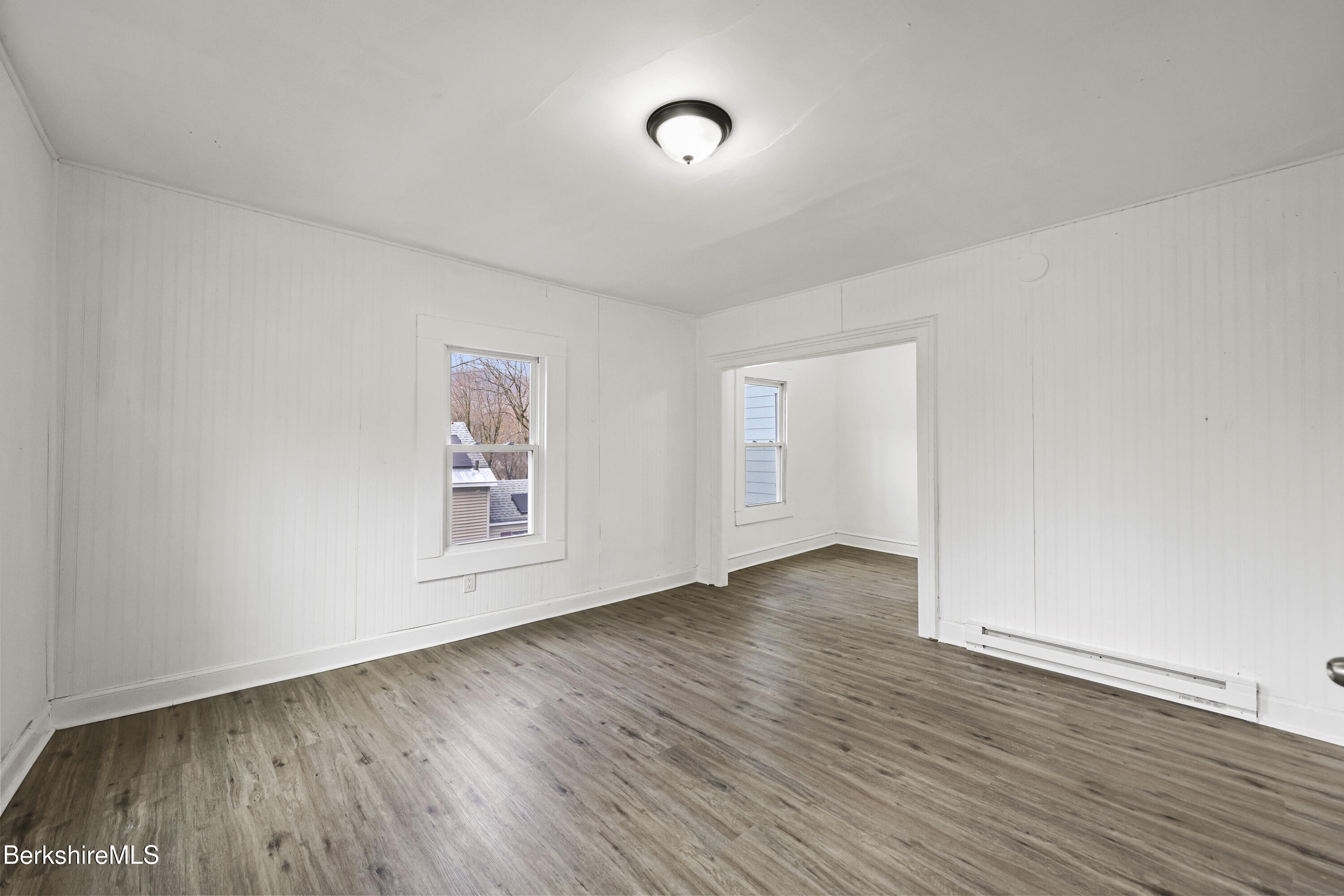 41 Prospect Street North Adams, MA 01247 - Photo 6 of 34 an empty room with wooden floor and windows