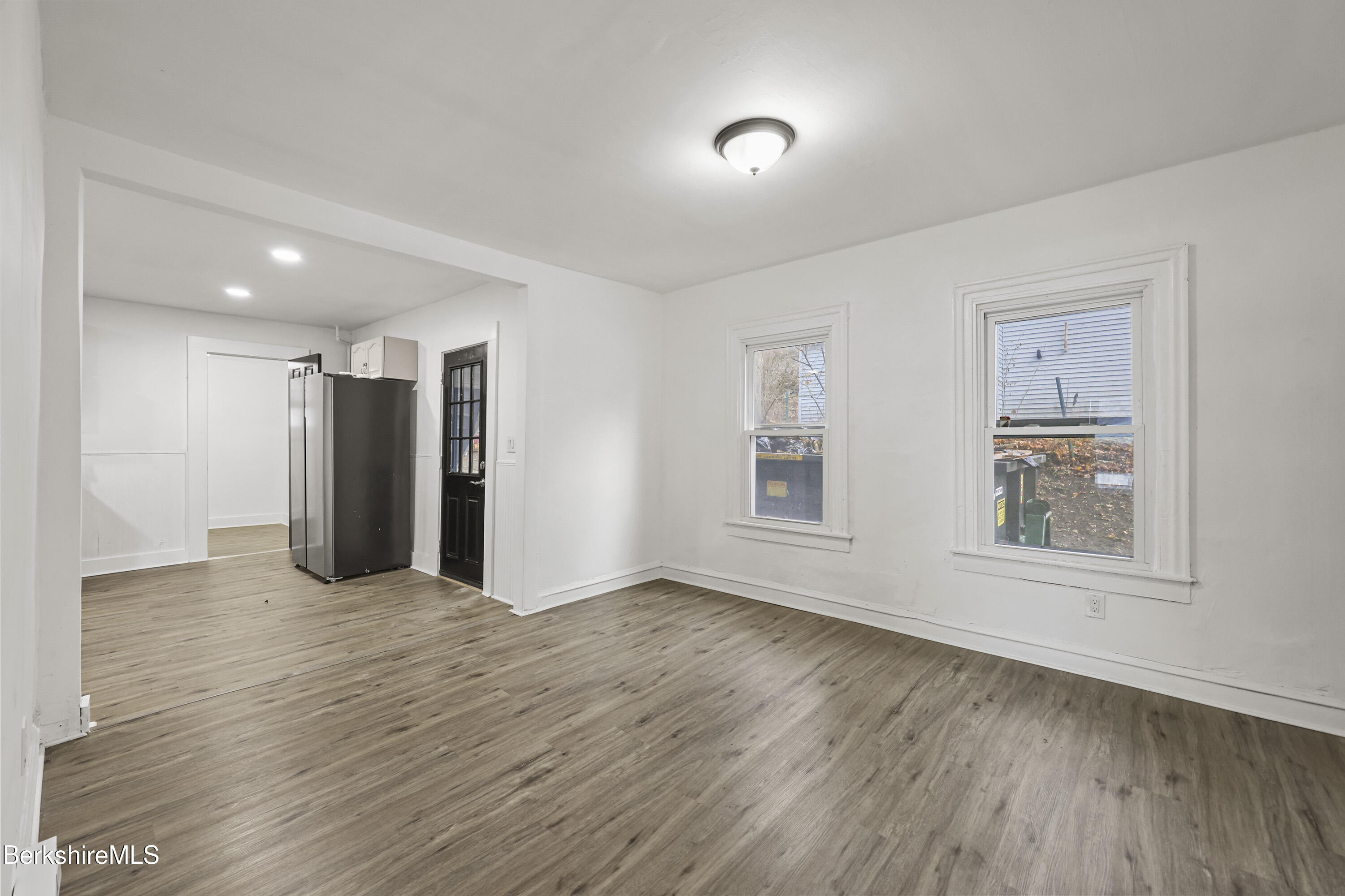 41 Prospect Street North Adams, MA 01247 - Photo 9 of 34 an empty room with wooden floor and windows