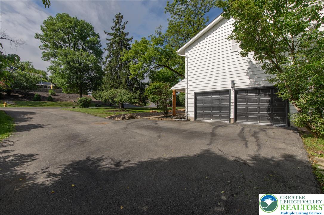 2011 Greenwood Road Allentown, PA 18103 - Photo 6 of 52 A spacious asphalt driveway leads to the two-car garage, offering ample parking and easy access.