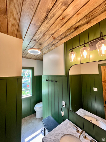 662 Earley Road Montpelier, ID 83254 - Photo 7 of 11 Bathroom featuring a wainscoted wall, vanity, wooden ceiling, wooden walls, and tile patterned flooring