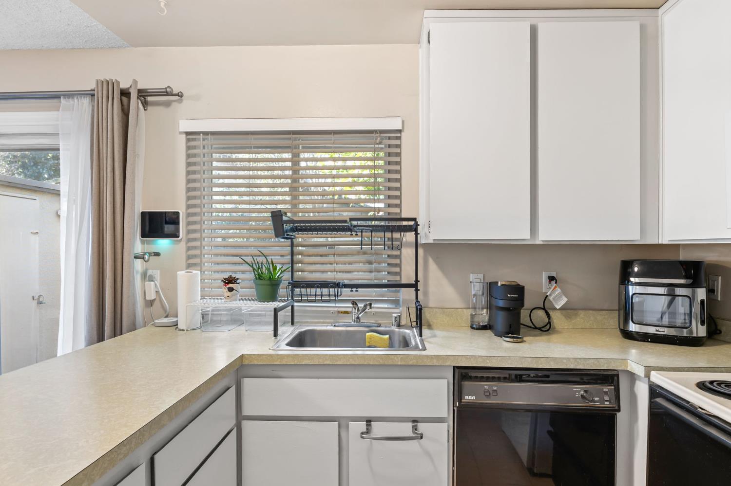 8849 La Riviera Drive, Unit A Sacramento, CA 95826 - Photo 12 of 19 a kitchen with a sink and cabinets