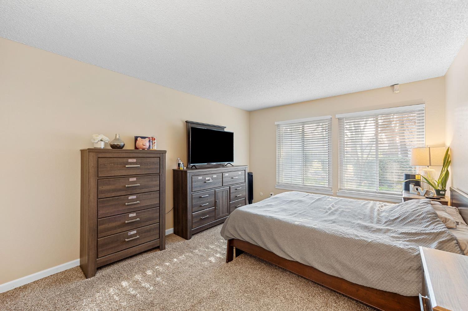 8849 La Riviera Drive, Unit A Sacramento, CA 95826 - Photo 15 of 19 a bedroom with a bed and flat screen tv