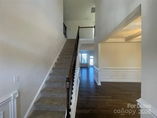 a view of entryway and hall with wooden floor