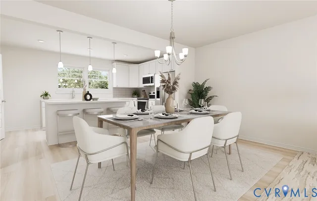 a view of a dining room with furniture a chandelier and wooden floor