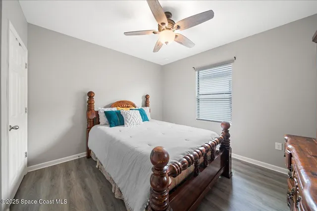 a bed sitting in a bedroom next to a window
