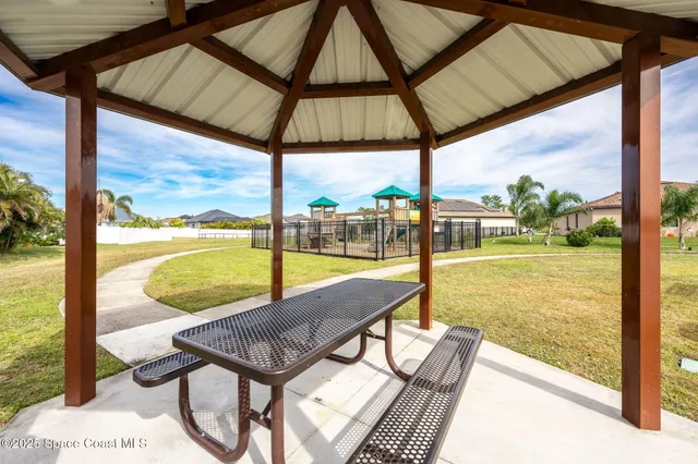 an aerial view of a city with lots of residential buildings and ocean view in back