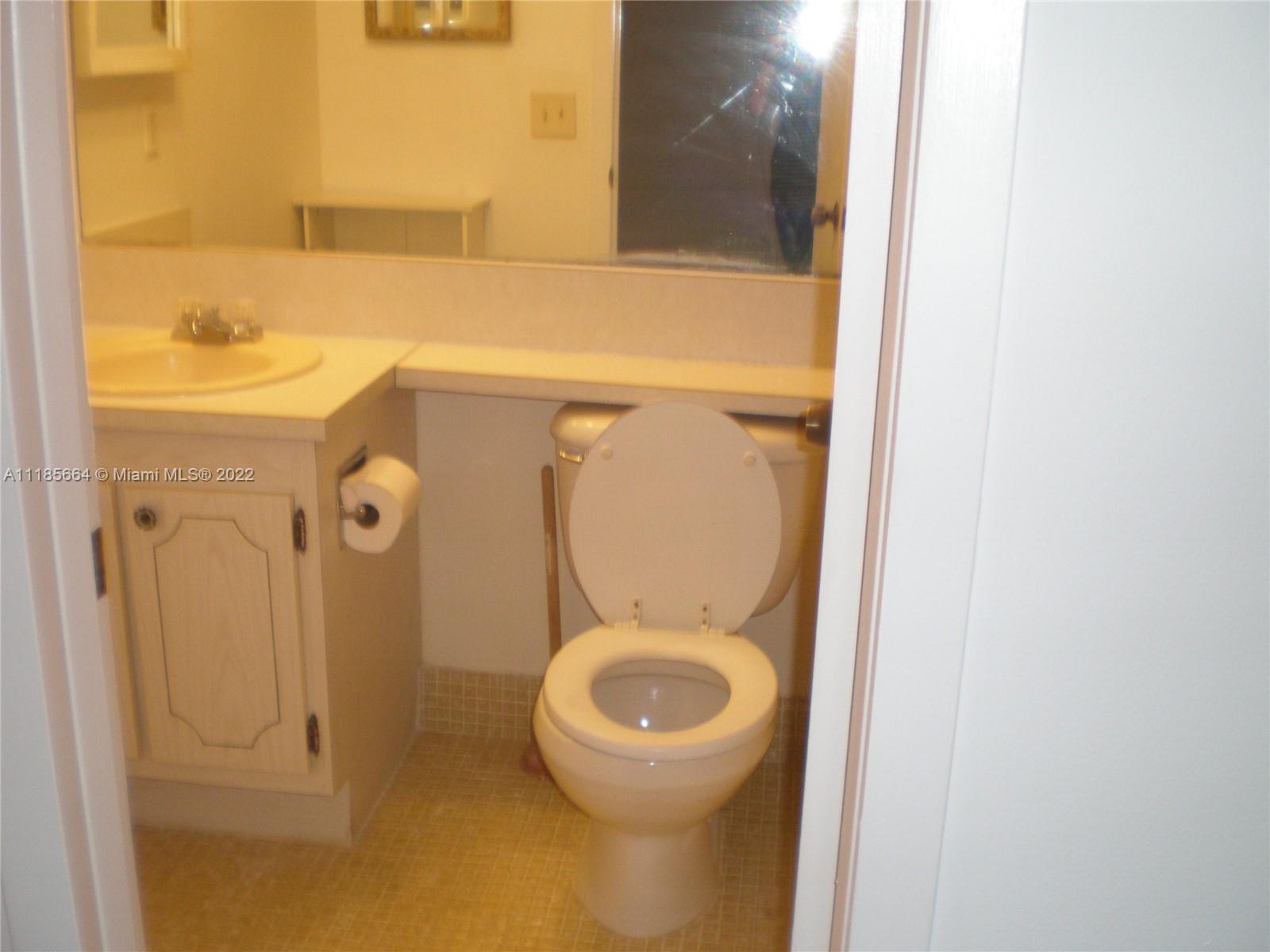 129 Brighton D, Unit 129 Boca Raton, FL 33434 - Photo 11 of 28 a bathroom with a toilet and a sink