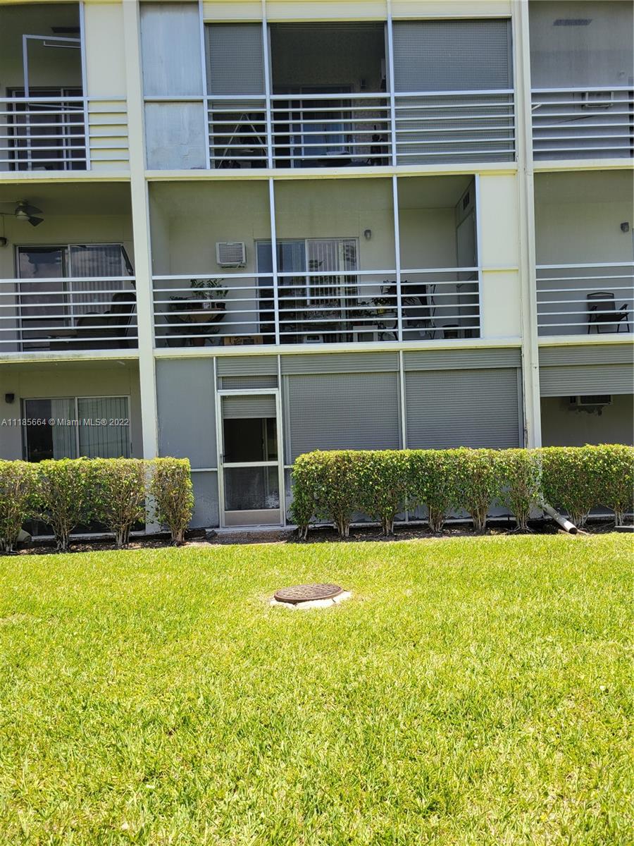 129 Brighton D, Unit 129 Boca Raton, FL 33434 - Photo 16 of 28 a view of house with a backyard
