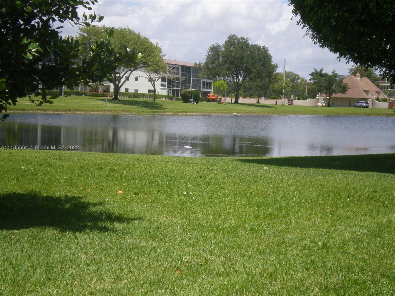 129 Brighton D, Unit 129 Boca Raton, FL 33434 - Photo 17 of 28 a view of a lake with houses