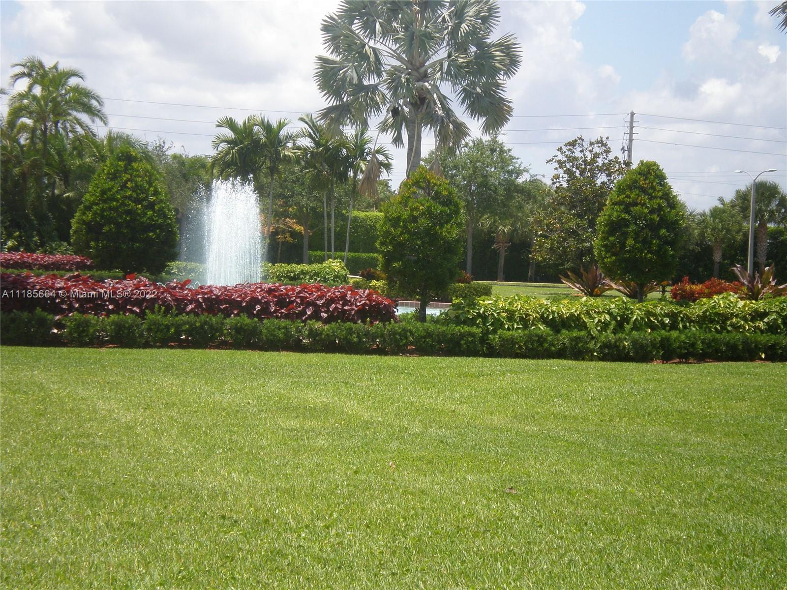 129 Brighton D, Unit 129 Boca Raton, FL 33434 - Photo 23 of 28 a view of a garden with flowers and trees