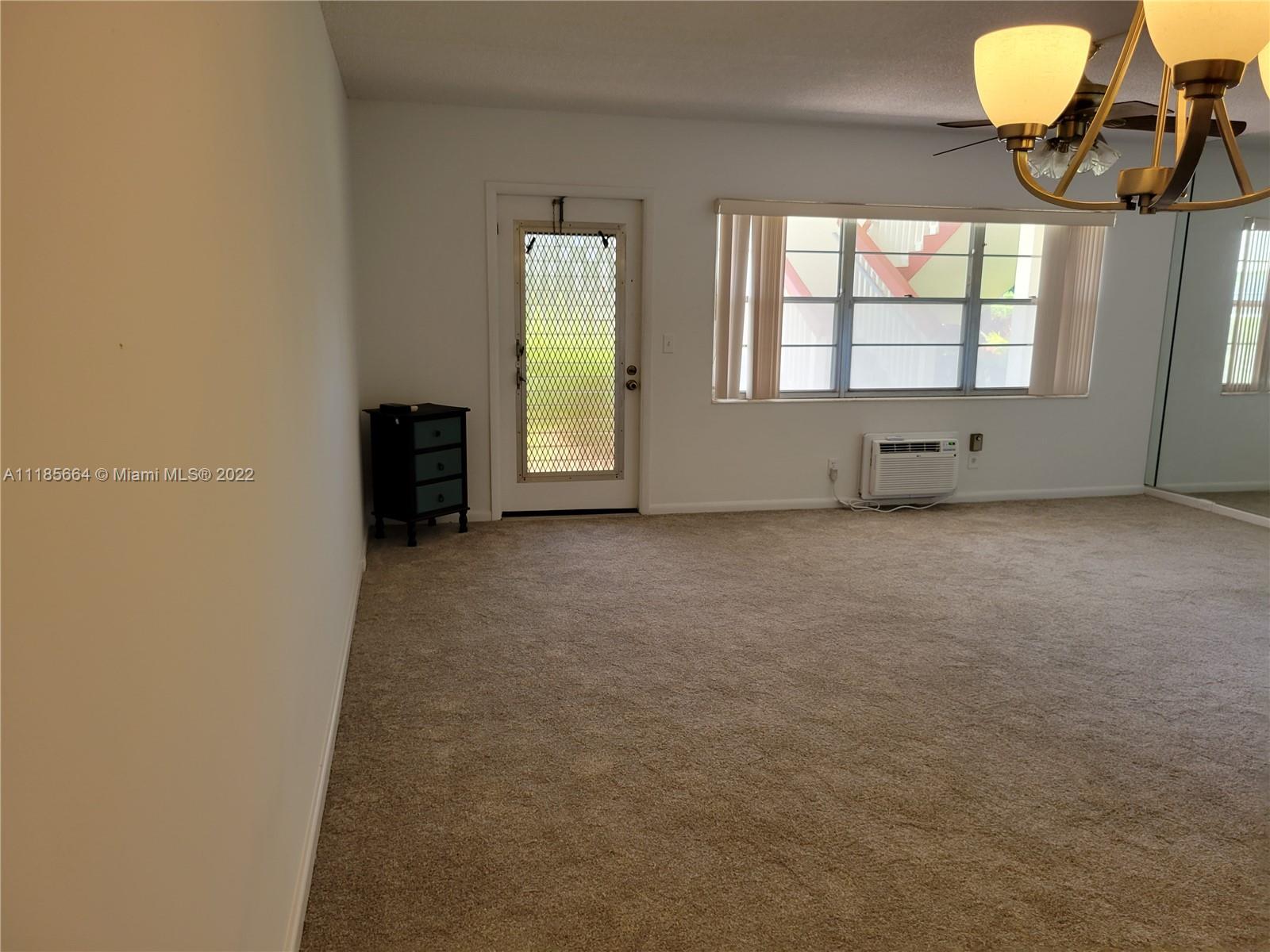 129 Brighton D, Unit 129 Boca Raton, FL 33434 - Photo 3 of 28 a view of an empty room and a window