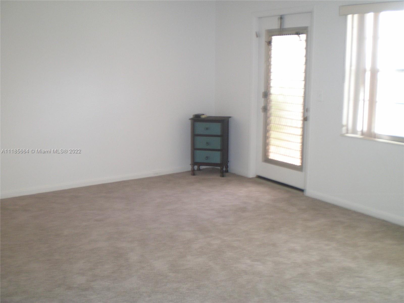 129 Brighton D, Unit 129 Boca Raton, FL 33434 - Photo 4 of 28 an empty room with a window