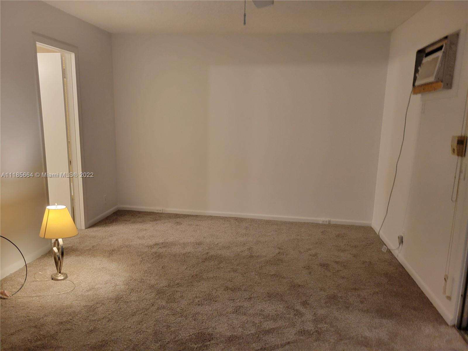 129 Brighton D, Unit 129 Boca Raton, FL 33434 - Photo 7 of 28 a view of an empty room and window