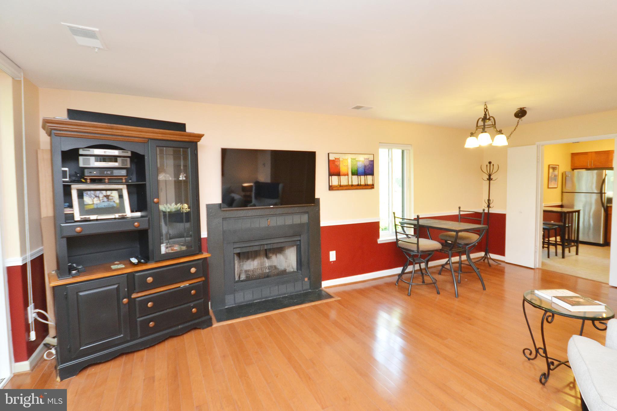 11214 Beaver Trail Court, Unit 12 Reston, VA 20191 - Photo 12 of 27 a living room with furniture and a flat screen tv