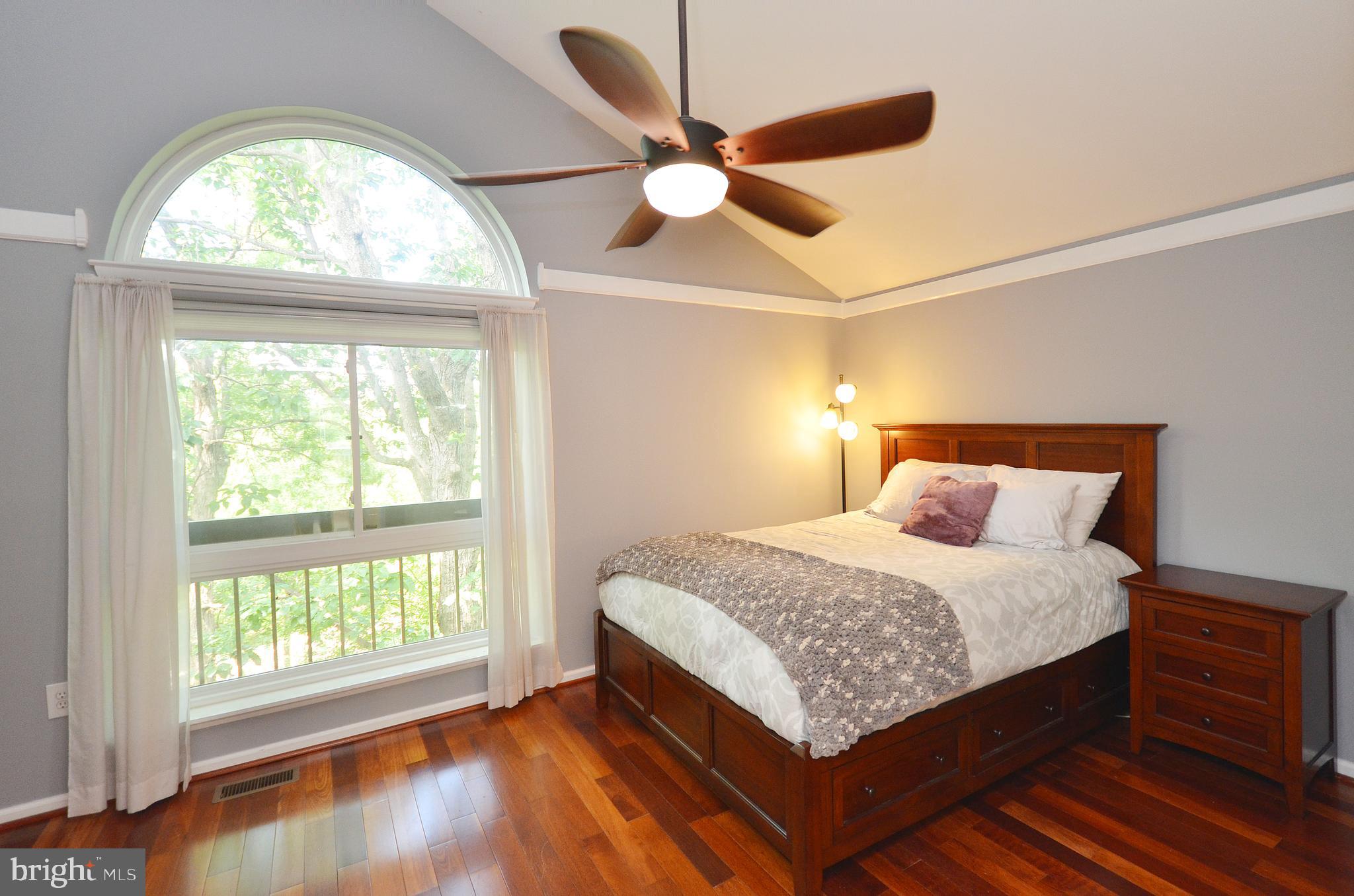 11214 Beaver Trail Court, Unit 12 Reston, VA 20191 - Photo 15 of 27 a bed sitting in a bedroom next to a window