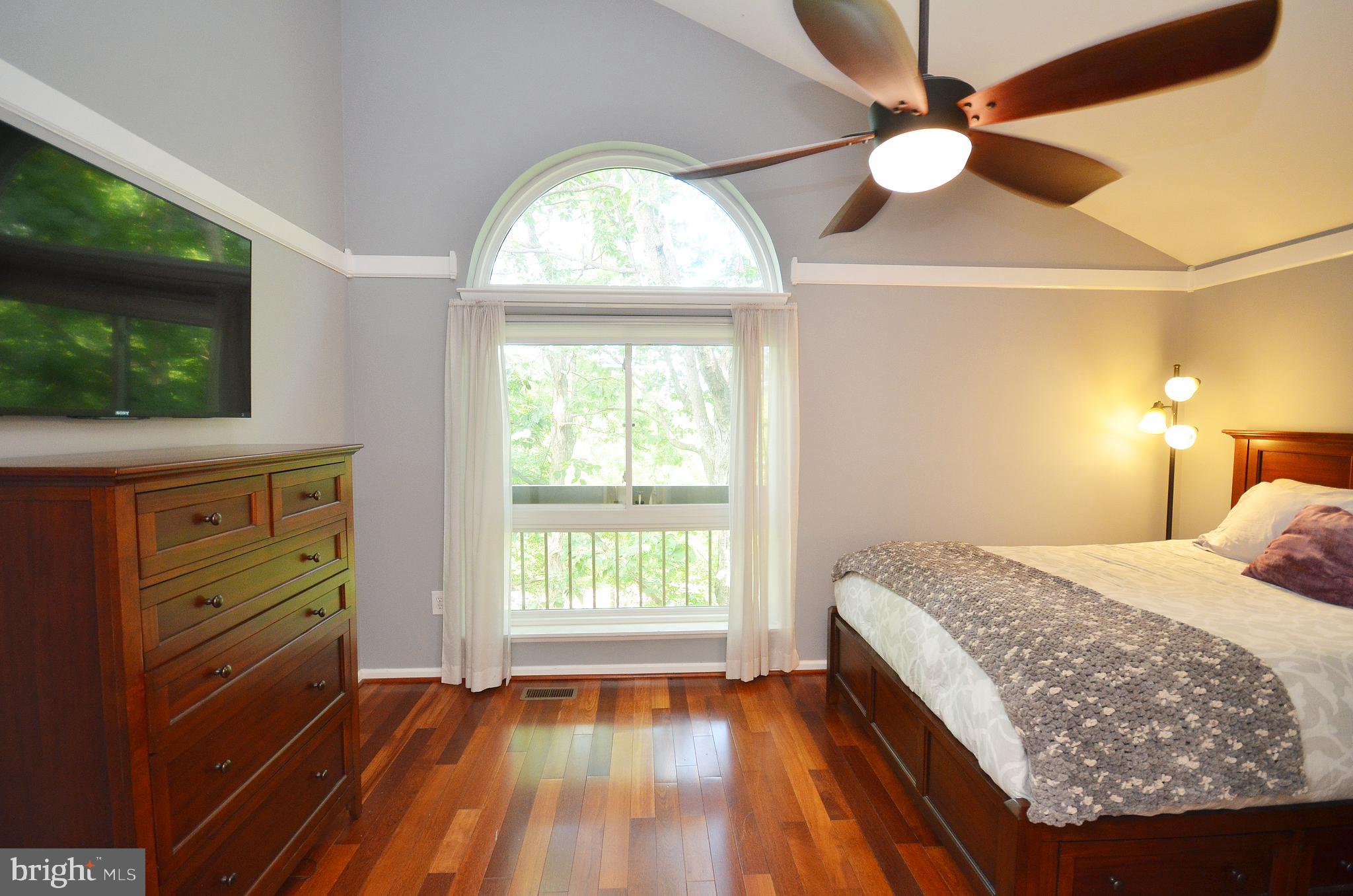 11214 Beaver Trail Court, Unit 12 Reston, VA 20191 - Photo 16 of 27 a bedroom with a bed and a flat screen tv