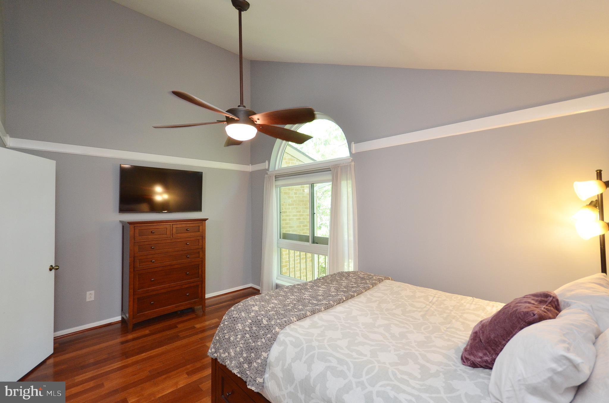 11214 Beaver Trail Court, Unit 12 Reston, VA 20191 - Photo 17 of 27 a bedroom with a bed and a flat screen tv